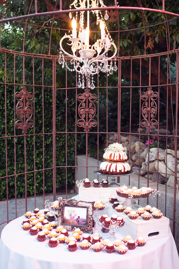 Wedding Photo by Christine Bentley Photography of Red and White dessert table with chandelier. 